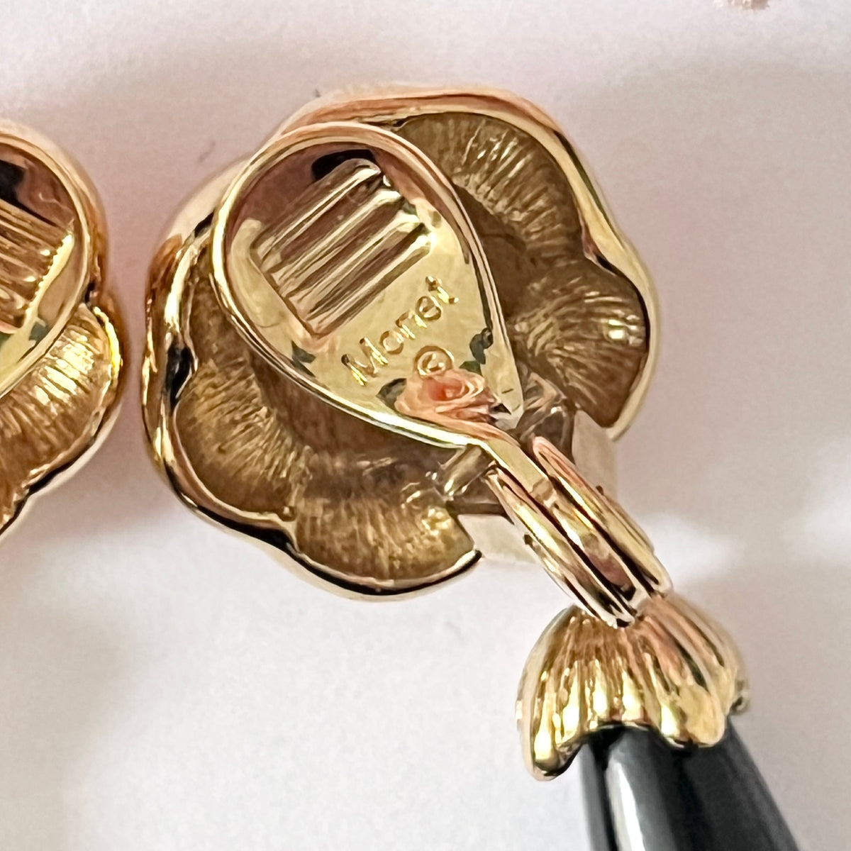 1980s Monet Gold Plated Flower Black Enamel Dangly Clip On Earrings