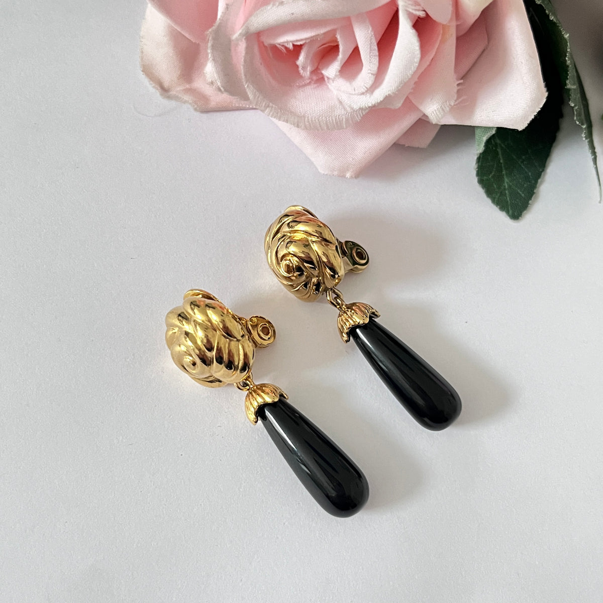 1980s Monet Gold Plated Flower Black Enamel Dangly Clip On Earrings