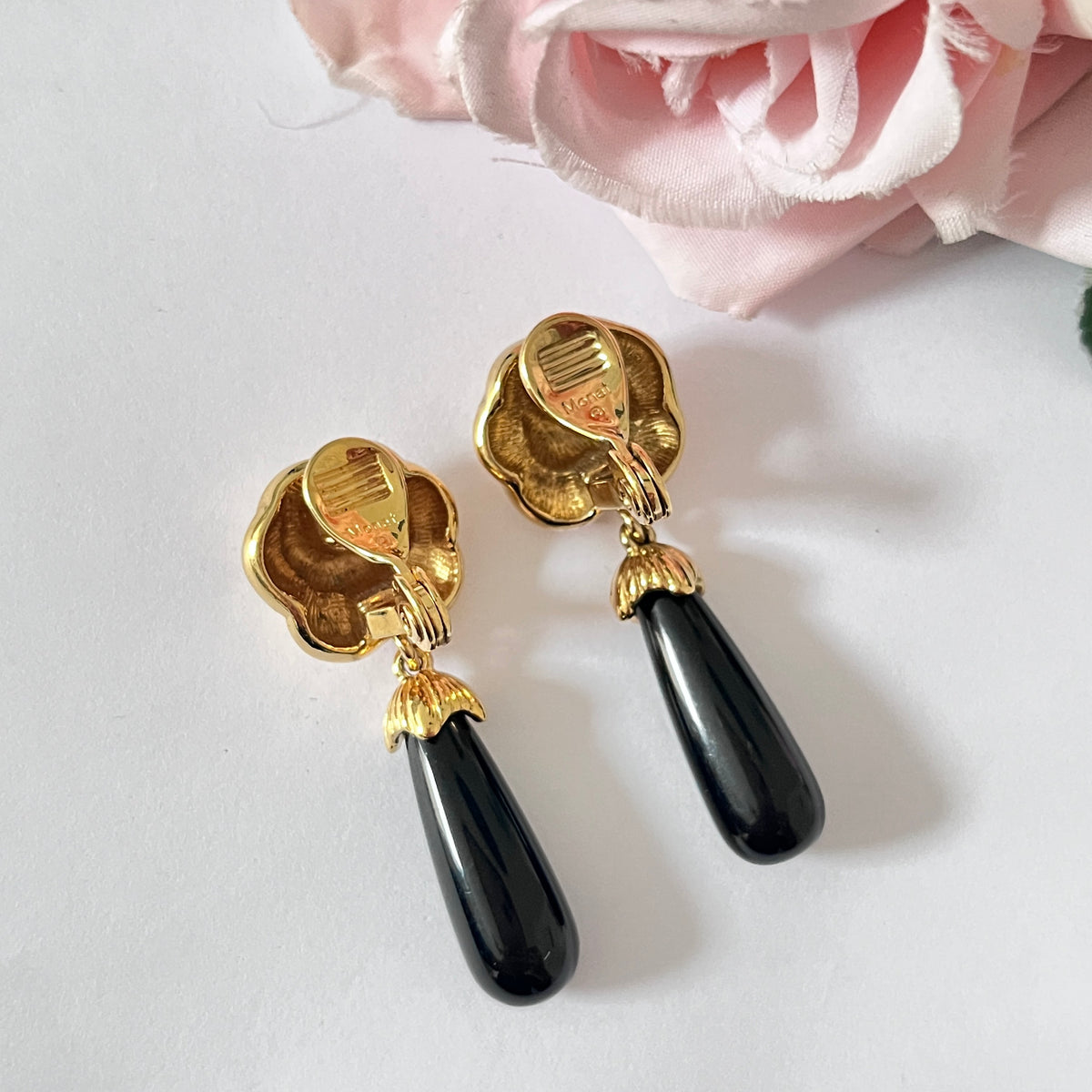 1980s Monet Gold Plated Flower Black Enamel Dangly Clip On Earrings