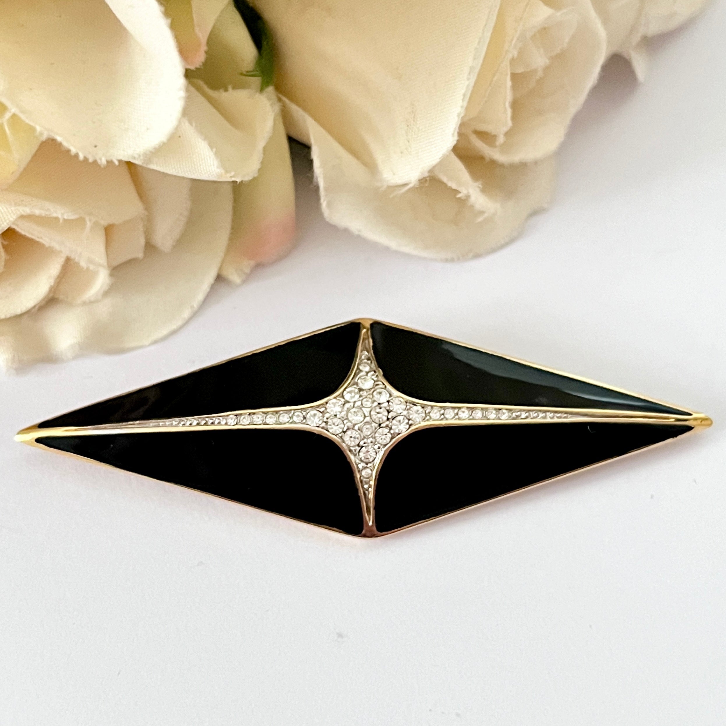 Black and 2024 gold brooch